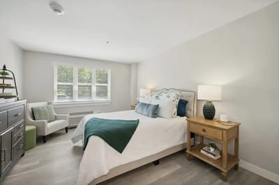 A bright and inviting private resident room with a bed.