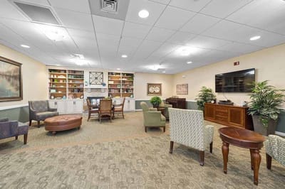 Bright common area with comfortable seating and bookshelves