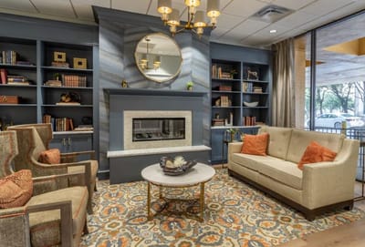 Cozy lounge area with seating and bookshelf