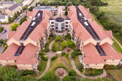 Aerial view of a senior living facility with gardens