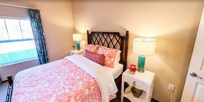 Cozy bedroom with floral bedding and decorative lamps