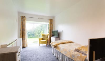 Interior view of a resident room with a garden view