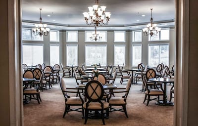 Dining area with tables and chairs in a well-lit room