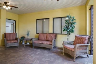 Interior common area with wicker furniture and windows