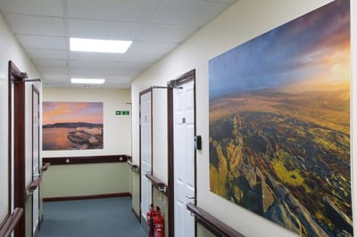 Interior hallway with framed landscape photographs