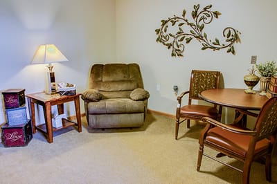 Cozy seating area with lamp and table in a resident room