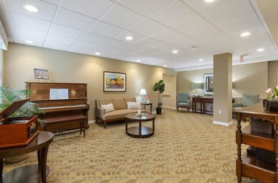 Bright and inviting common area with seating and piano