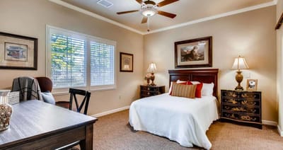 Cozy private resident room with a bed and desk