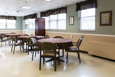 Empty dining area with circular tables and chairs