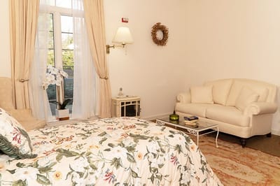 Cozy resident room with floral bedding and a comfortable seating area
