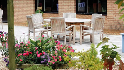 Outdoor seating area with colorful flowers