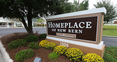 Signage for Home Place of New Bern with landscaping