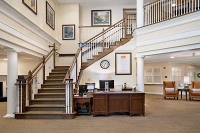Interior view of a welcoming lobby with a staircase