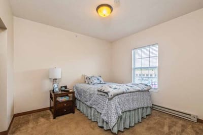 Cozy private bedroom with a single bed and lamp