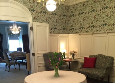 Cozy common area with floral wallpaper and seating