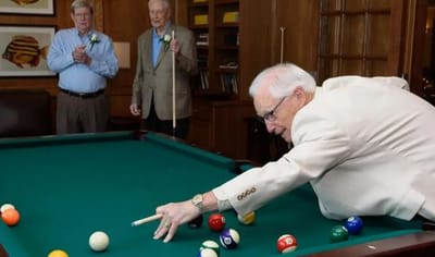 Residents playing billiards in a common area