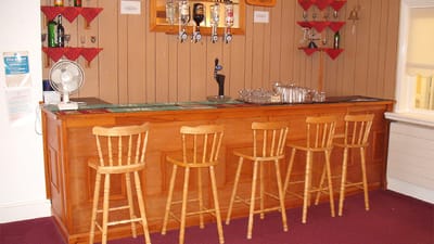 Interior view of a wooden bar with stools