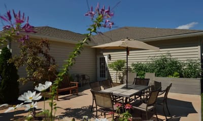 Outdoor patio area with seating and flowers