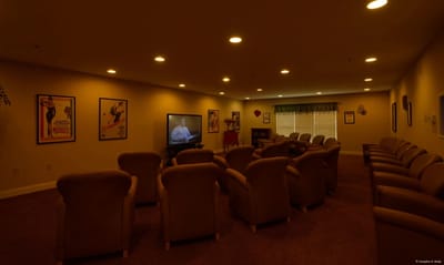 Interior view of a cozy common area with seating and a TV