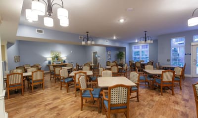 Bright dining area with wooden floors and tables