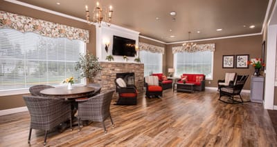 Bright and cozy common area with seating and fireplace