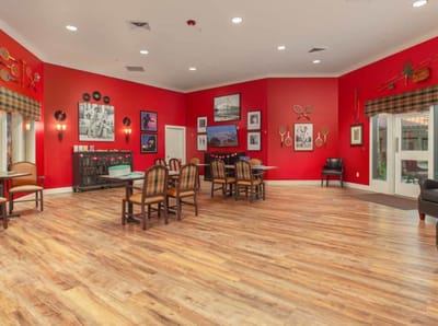 Bright common area with red walls and wooden floor