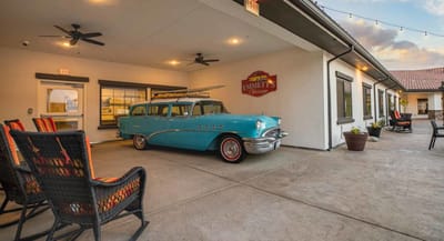 Classic car in a cozy outdoor patio area of the facility