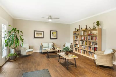Brightly lit common area with seating and bookshelves