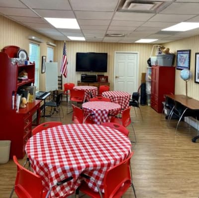 Bright activity room with red checkered tables
