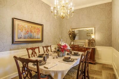 Elegant dining room with chandelier and floral centerpiece
