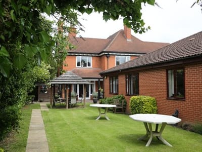Outdoor area with tables and garden space at Lavender House