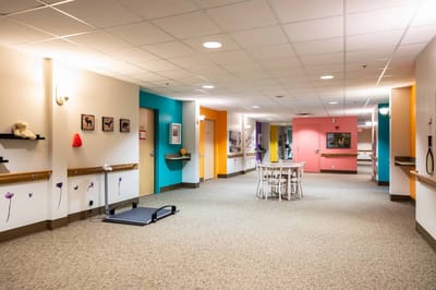 Brightly colored interior hallway with seating area