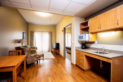 Interior view of a resident's room with kitchenette