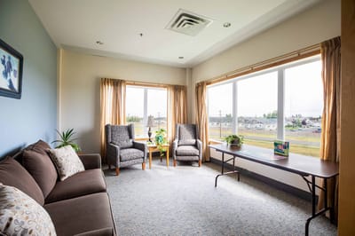 Bright common area with seating and large windows