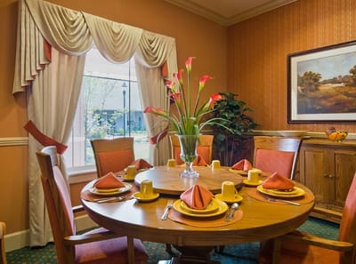 Dining room with a beautifully set table and flowers