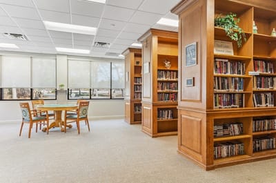 Interior view of a library with bookshelves and a table