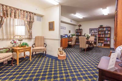 Cozy common area with seating and a bookshelf