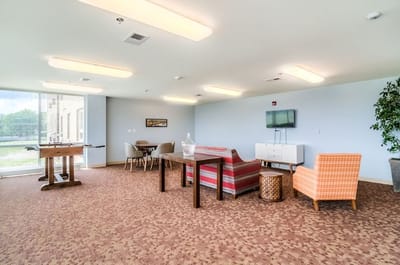 Bright common area with seating and a television