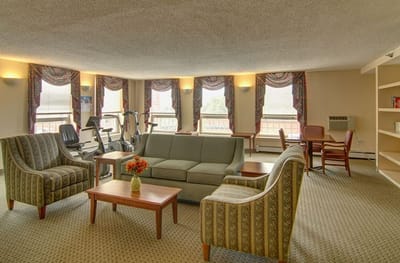 Cozy common area with seating and exercise equipment