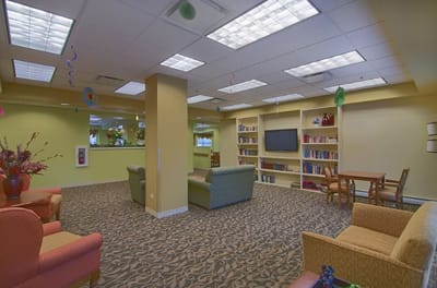 Bright interior common area with seating and bookshelf