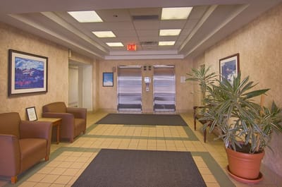 A hallway in a senior living facility with seating areas
