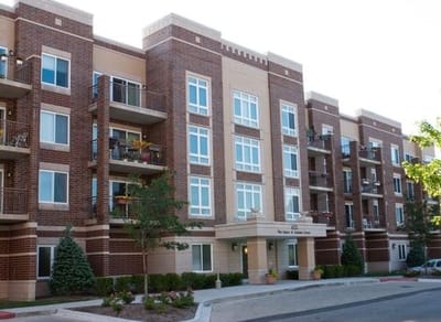 Exterior of Senior Suites Wright Campus featuring brick facade and balconies.