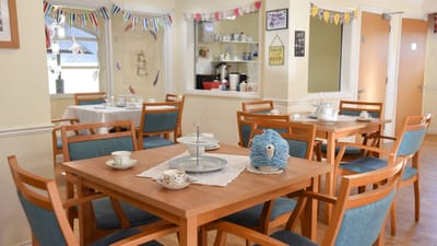 Dining area with tables set for service and decorative accents