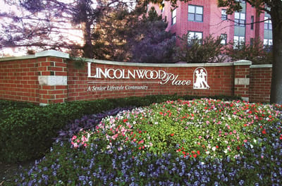 Exterior view of Lincolnwood Place facility sign with flowers