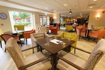 Bright communal area with colorful chairs and tables