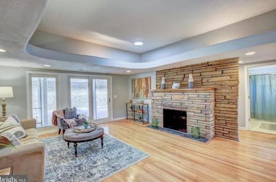 Bright living room with a stone fireplace