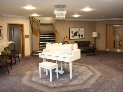 Interior of a cozy lounge area with a piano