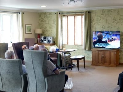 Residents watching TV in a cozy common area