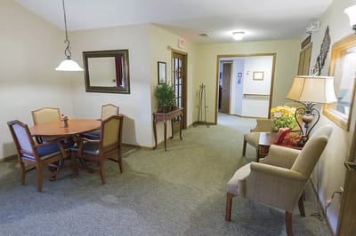 A cozy common area with dining table and chairs
