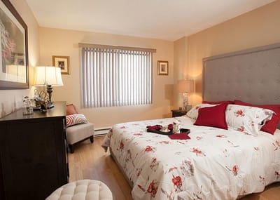 Cozy private bedroom with floral bedding and soft lighting